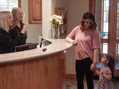 young patient talking with the front office staff at Family Dental Center after her appointment