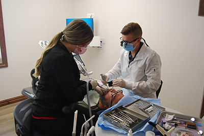 Dr. Scott Gardner and his assistant providing dental care for a patient at Family Dental Center