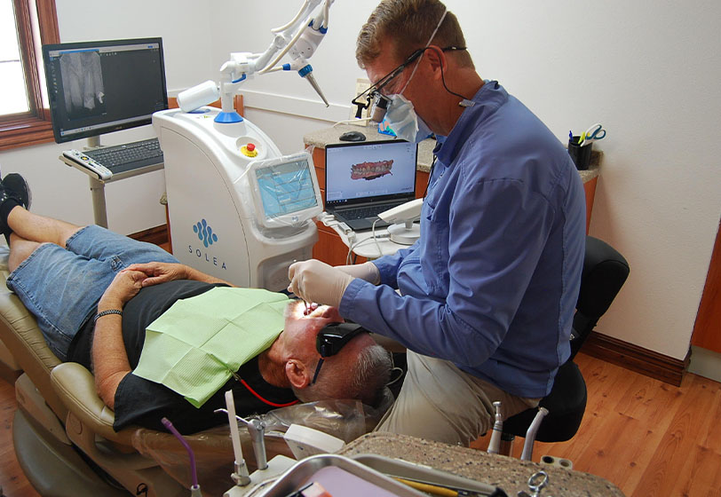 Dr. Scott Gardner providing dental care for a patient at Family Dental Center in Nampa, ID